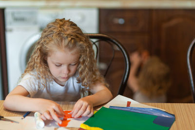 Girl doing craft while sitting at home