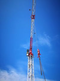 Low angle view of crane against blue sky