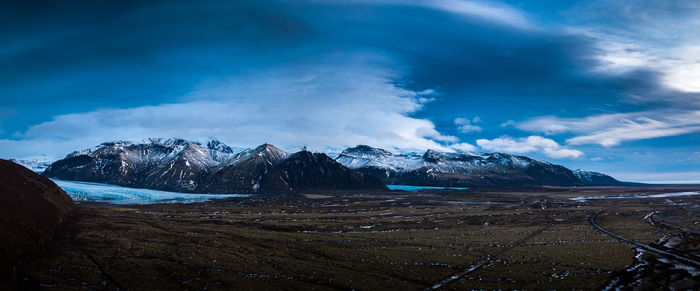 Scenic view of mountains against blue sky