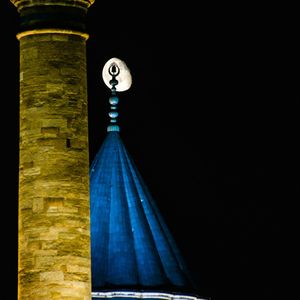 Close-up of illuminated lamp against black background