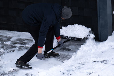 Low section of man skiing on snow