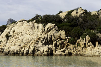 Costa smeralda ladscape of granite rock formation and vegetation in the sea shore of sardinia, italy