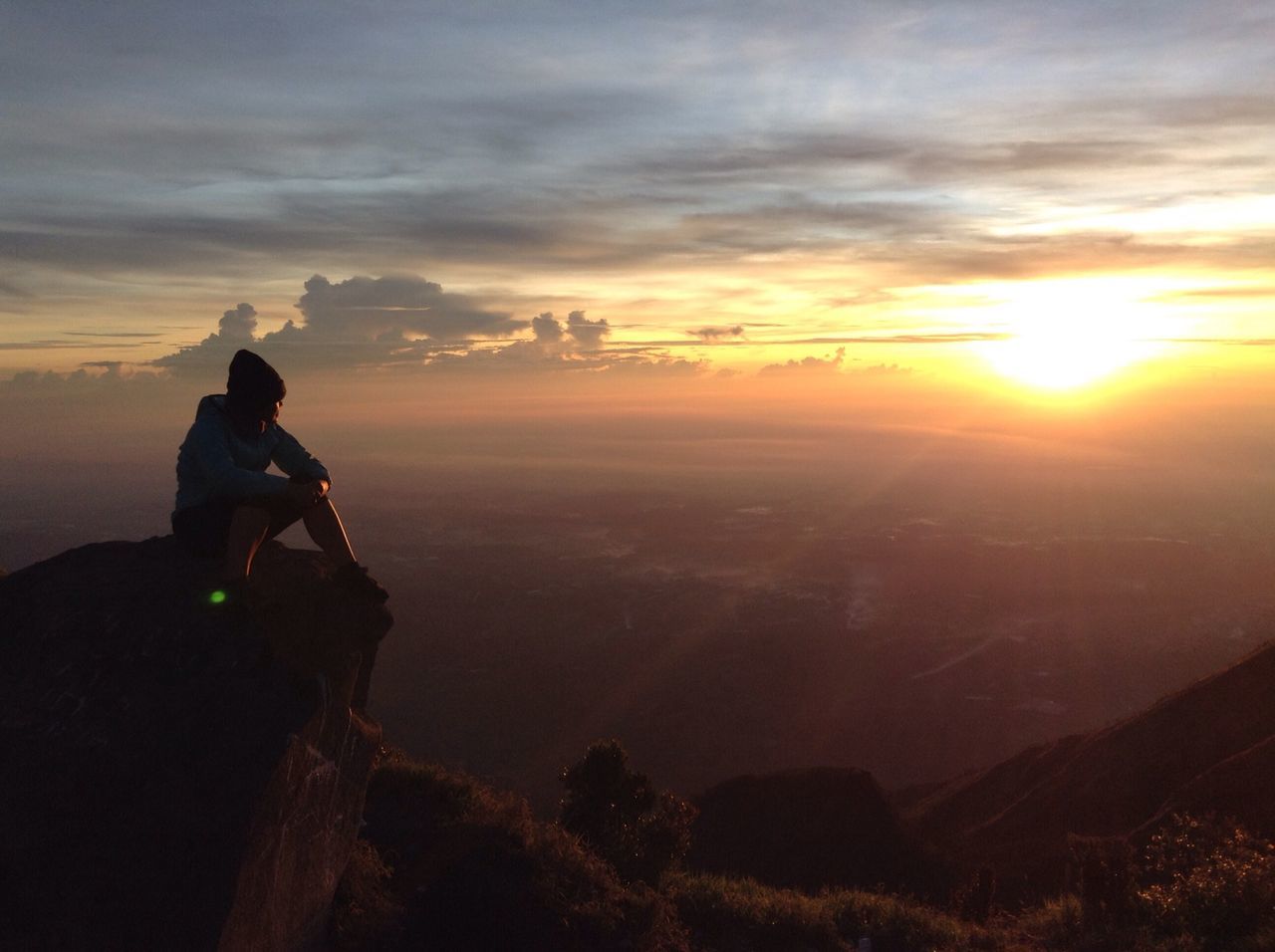 sunset, landscape, sky, mountain, scenics, lifestyles, beauty in nature, tranquil scene, leisure activity, sun, tranquility, orange color, silhouette, men, cloud - sky, nature, looking at view, standing