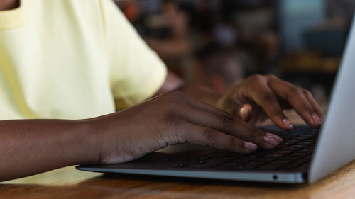Midsection of man using laptop