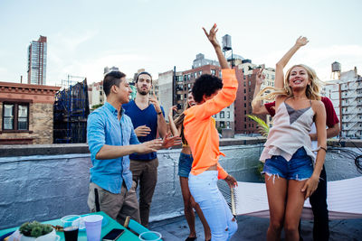 Portrait of people dancing against building