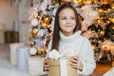 Portrait of a smiling girl in a christmas tree