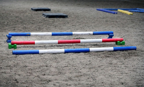 High angle view of colored pencils on sand