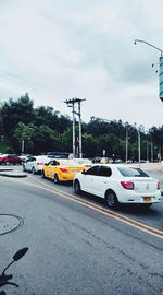 Traffic on road in city against sky