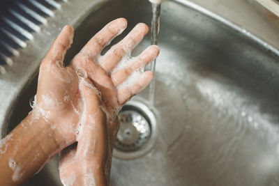 Midsection of man in bathroom at home