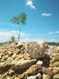 Rocks by sea against sky