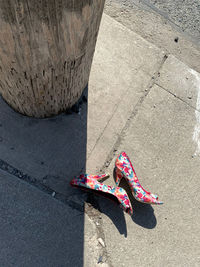 Low section of woman standing on street