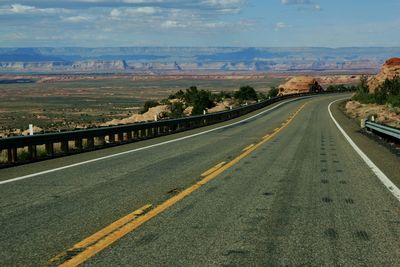 In northern arizona an open road leads through the desert curving into the horizon.