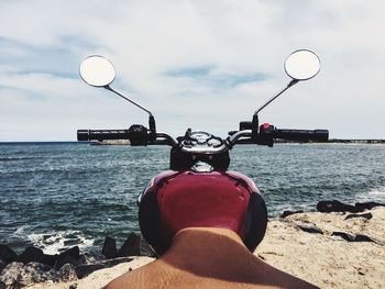 Motorcycle at beach on sunny day