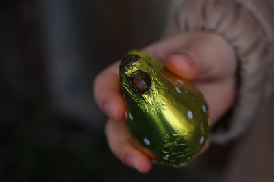 Close-up of hand holding easter chocolate 