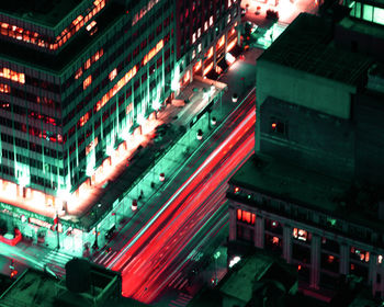 High angle view of illuminated street amidst buildings in city