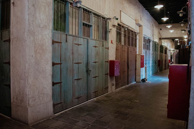 Footpath amidst buildings in city at night