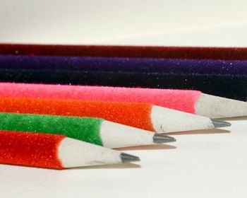 Close-up of colored pencils against white background