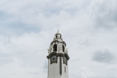 Low angle view of cross on building against sky