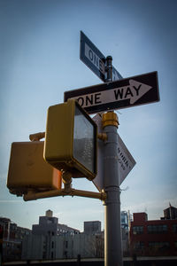 Low angle view of road sign against clear sky