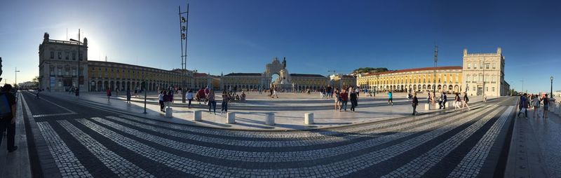 Panoramic shot of people at praca do comercio against sky