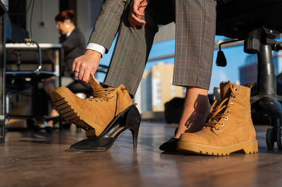 Low section of woman standing on hardwood floor