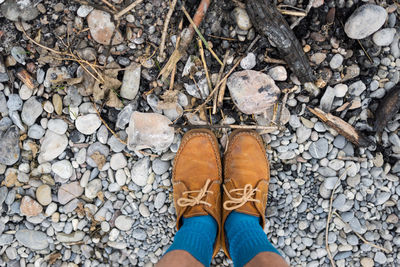 Low section of person standing on stones