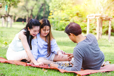 Young couple sitting on grass