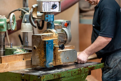 Midsection of man working in workshop