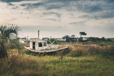 Abandoned built structure on field against sky