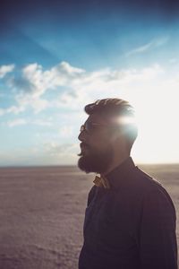 Portrait of a young man against desert