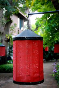 Close-up of red mailbox on building in city