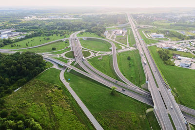 Cars moving on transport road junction in city, aerial view