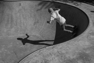 Rear view of boy skateboarding on skateboard