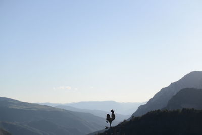 Man on mountain against sky