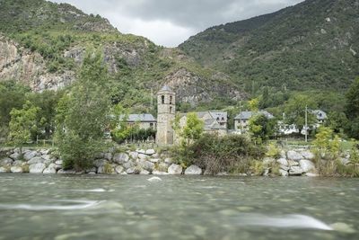 Scenic view of river amidst trees against sky