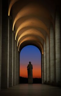 Statue in building against sky