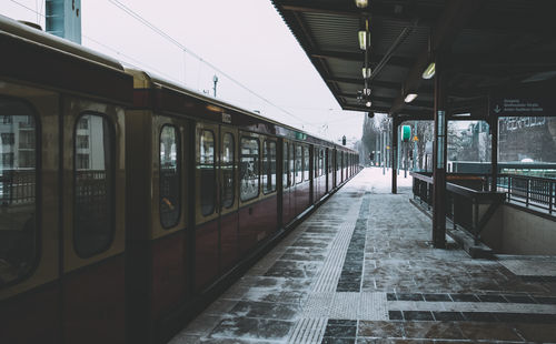 Train at railroad station against sky