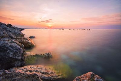 Scenic view of sea against sky at sunset