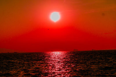 Scenic view of sea against orange sky