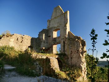 Low angle view of old building against clear sky