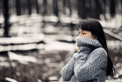 Portrait of young woman in snow