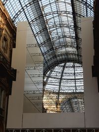 Low angle view of glass building against sky