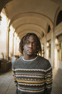 Young man standing in corridor