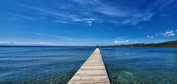 Pier over sea against sky