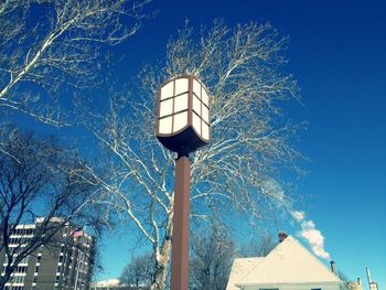 Low angle view of illuminated building against blue sky