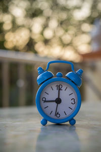 Close-up of clock on table