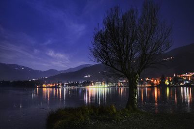 Scenic view of lake against sky at night