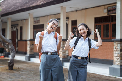 Female friends standing in city