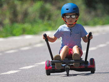 Boy riding skateboard on road