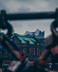 View of amusement park against cloudy sky